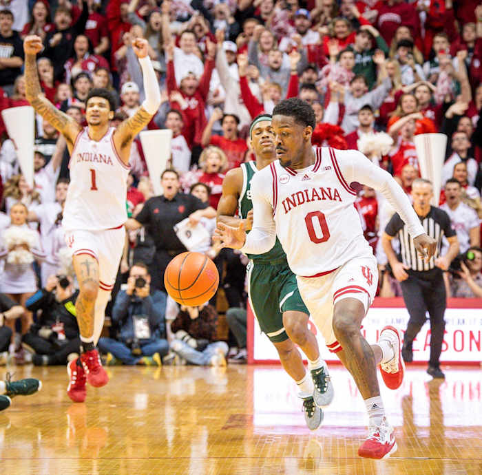 Indiana's Xavier Johnson (0) runs out the clock as Kel'el Ware (1) starts celebrating the victory during Indiana's game against Michigan State at Simon Skjodt Assembly Hall on Sunday, March 10, 2024.